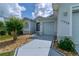 Exterior view of home with a well-manicured lawn and a driveway leading to the garage at 15268 Sw 14Th Avenue Rd, Ocala, FL 34473