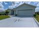 Home exterior featuring a decorative driveway and a well-maintained lawn with a manicured shrub at 15268 Sw 14Th Avenue Rd, Ocala, FL 34473