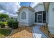 Exterior front view showcasing a well-maintained yard and entryway at 15268 Sw 14Th Avenue Rd, Ocala, FL 34473