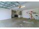 Spacious two car garage featuring painted block walls, laundry, storage, and an automatic door at 15268 Sw 14Th Avenue Rd, Ocala, FL 34473