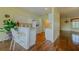 A kitchen with a breakfast bar and white appliances flows into a living area at 15268 Sw 14Th Avenue Rd, Ocala, FL 34473