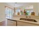 Bright kitchen with stainless steel sink, and decorative accents, open to the outdoor patio at 15268 Sw 14Th Avenue Rd, Ocala, FL 34473