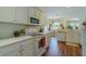 Bright kitchen with white appliances, ample countertop space, and adjacent dining area, perfect for Gathering meals and entertaining at 15268 Sw 14Th Avenue Rd, Ocala, FL 34473