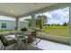 Enclosed lanai with tile flooring, outdoor seating, and panoramic views of the golf course at 15268 Sw 14Th Avenue Rd, Ocala, FL 34473