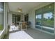 Outdoor seating on a screened lanai, adjacent to sliding glass doors that lead indoors at 15268 Sw 14Th Avenue Rd, Ocala, FL 34473