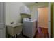 Bright laundry room showcasing a utility sink, washer, and dryer on wood-look flooring at 15268 Sw 14Th Avenue Rd, Ocala, FL 34473