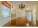 Open-concept living space boasts hardwood floors, elegant lighting, and seamless transition to the outdoors through sliding doors at 15268 Sw 14Th Avenue Rd, Ocala, FL 34473