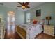 The main bedroom features light blue walls, hard wood floors, and an elegant fan at 15268 Sw 14Th Avenue Rd, Ocala, FL 34473