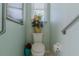 This private toilet room features decorative accessories and safety features like grab bars at 15268 Sw 14Th Avenue Rd, Ocala, FL 34473