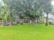 Large backyard with lush grass and screened patio at 2733 Scarborough Dr, Kissimmee, FL 34744