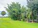 Landscaped backyard with tropical plants and pond feature at 2733 Scarborough Dr, Kissimmee, FL 34744