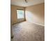 Simple bedroom with neutral walls, carpeted floors, and a window at 2733 Scarborough Dr, Kissimmee, FL 34744