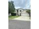Two-story house with a large driveway and landscaped yard at 2733 Scarborough Dr, Kissimmee, FL 34744