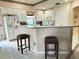 Kitchen island with seating and white cabinetry at 2733 Scarborough Dr, Kissimmee, FL 34744