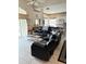 Living area with a sectional sofa, coffee table, and view of kitchen at 2733 Scarborough Dr, Kissimmee, FL 34744