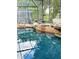 Resort-style pool with a rock formation and screened enclosure at 2733 Scarborough Dr, Kissimmee, FL 34744