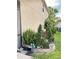 Landscaped side yard with plants, trees, and stone features at 2733 Scarborough Dr, Kissimmee, FL 34744