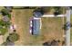 Birds-eye view of a rural home with a well-kept lawn, outbuilding, and proximity to nature at 4011 Se 47Th Pl, Ocala, FL 34480