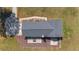 A high definition overhead view of a house with a dark gray roof and backyard patio at 4011 Se 47Th Pl, Ocala, FL 34480
