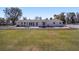 Expansive backyard with a large patio, well-maintained lawn, and mature trees offering both space and privacy at 4011 Se 47Th Pl, Ocala, FL 34480