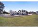 Spacious backyard showcasing lush green grass and a concrete patio, great for gatherings and outdoor activities at 4011 Se 47Th Pl, Ocala, FL 34480