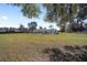 Substantial backyard featuring a spacious lawn, mature trees, and a view of the home's rear exterior at 4011 Se 47Th Pl, Ocala, FL 34480