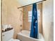 Bathroom showcasing a shower with a curtain, toilet, tub, and tile surround at 4011 Se 47Th Pl, Ocala, FL 34480