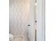 Stylish half bathroom with a modern leaf-patterned wallpaper at 4011 Se 47Th Pl, Ocala, FL 34480