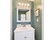 Cozy bathroom features a white vanity, stylish mirror and wall paint at 4011 Se 47Th Pl, Ocala, FL 34480