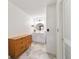 Bright bathroom features a large vanity, sleek lighting, and a wood dresser at 4011 Se 47Th Pl, Ocala, FL 34480