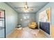Comfortable bedroom with a ceiling fan, a plush rug and chair, and a large window at 4011 Se 47Th Pl, Ocala, FL 34480