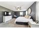 Primary bedroom featuring a walk in closet, dresser, ceiling fan, and soft carpet at 4011 Se 47Th Pl, Ocala, FL 34480
