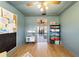 Cozy bedroom with hard wood floors, toys and books, and access to the breakfast nook at 4011 Se 47Th Pl, Ocala, FL 34480
