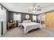 Spacious primary bedroom featuring soft carpet, barn door and white trim at 4011 Se 47Th Pl, Ocala, FL 34480