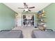 Spacious bedroom featuring twin beds, open shelving, a walk-in closet, and a ceiling fan at 4011 Se 47Th Pl, Ocala, FL 34480