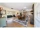 Spacious dining area featuring a large area rug, fireplace, and extensive bookshelf at 4011 Se 47Th Pl, Ocala, FL 34480