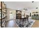 Dining area with an accent fireplace, open shelving, wood dining table set, and area rug at 4011 Se 47Th Pl, Ocala, FL 34480