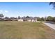 Expansive front lawn leading to a charming single-story home with neutral exterior and lovely curb appeal at 4011 Se 47Th Pl, Ocala, FL 34480