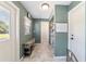 Inviting hallway features stylish tile floors, a convenient bench, and access to storage space at 4011 Se 47Th Pl, Ocala, FL 34480