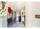 Inviting hallway with neutral paint, decorative wreath, bench seating, and tiled floor at 4011 Se 47Th Pl, Ocala, FL 34480