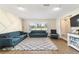 Open-concept living room with sofas, large windows, view into dining area, and hardwood floors at 4011 Se 47Th Pl, Ocala, FL 34480