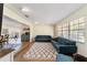 Bright living room with stylish furniture, large windows, wood floors, and open to dining area at 4011 Se 47Th Pl, Ocala, FL 34480