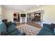 Cozy living room featuring a blue sofa, decorative rug, and seamless flow into dining space at 4011 Se 47Th Pl, Ocala, FL 34480