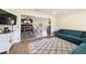 Open concept living room with views to the dining area, a comfortable couch, and wood flooring at 4011 Se 47Th Pl, Ocala, FL 34480