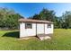 Close up view of the shed in the backyard with white paneling at 4011 Se 47Th Pl, Ocala, FL 34480