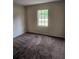 Carpeted bedroom offering natural light and neutral wall color at 4 Spring Trl, Ocala, FL 34472