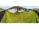 Spacious backyard with covered patio, grill, and fenced perimeter at 5172 Nw 46Th Lane Rd, Ocala, FL 34482