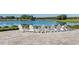 Relaxing patio area with lake views and white Adirondack chairs at 5172 Nw 46Th Lane Rd, Ocala, FL 34482