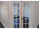 White double doors with glass panes open to a view of another room at 8193 Sw 127Th Ave, Dunnellon, FL 34432