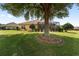 Well-maintained backyard featuring mature trees, landscaping, and screened-in patio at 8463 Sw 84Th Loop, Ocala, FL 34481
